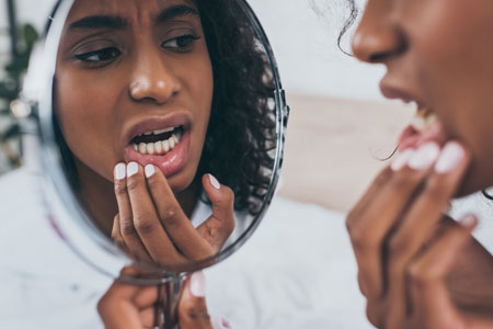 woman needing an emergency dentist in Woburn, MA