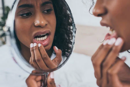 woman needing an emergency dentist in Woburn, MA