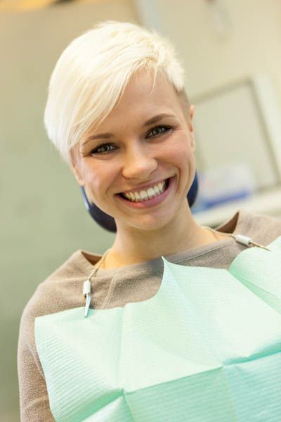woman smiling during her cosmetic dentistry appointment at Radiant Dentistry of Woburn