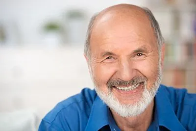 man smiling with all-on-4 dentures from Radiant Dentistry of Woburn