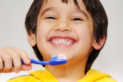 young child brushing his teeth