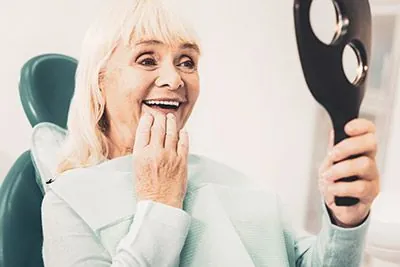 woman loving her dentures from Radiant Dentistry of Woburn