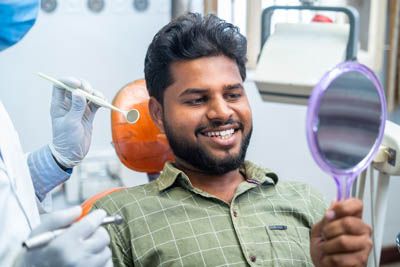 man satisfied with the results of his restorative dentistry appointment at Radiant Dentistry of Woburn